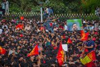 Fans of Royal Challengers Bengaluru (RCB) celebrate before the start of the trophy parade after they win the 2025 IPL, on June 04, 2025 in Bengaluru
