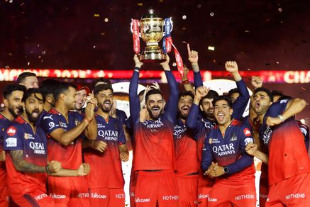Virat Kohli of Royal Challengers Bengaluru lifts the IPL trophy alongside teammates following the team's victory in the 2025 IPL Final match between Royal Challengers Bengaluru and Punjab Kings at Narendra Modi Stadium, Ahmedabad, June 3, 2025
