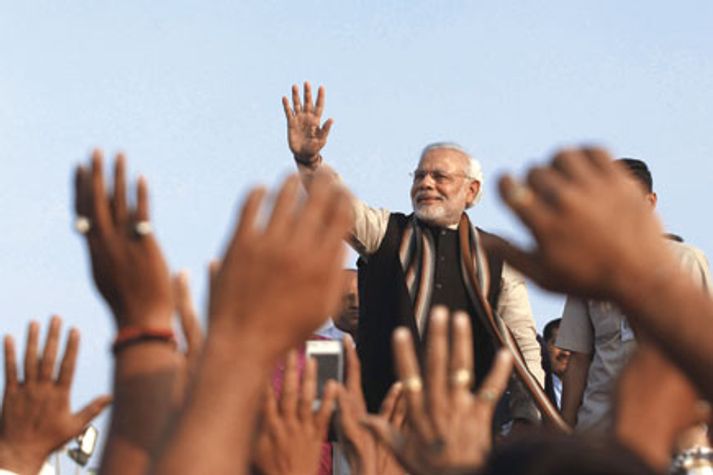 Narendra Modi greets supporters in Ahmedabad, 2013