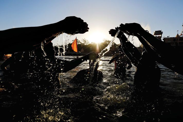 Devotees offer water to the Sun God on the first day of the month-long Simhastha Mela in Ujjain