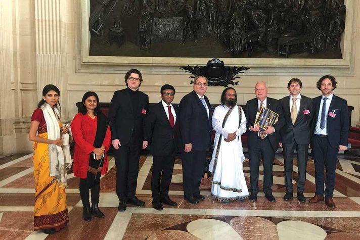 Sri Sri with Paul Giacobbi, president of the Indo-French Friendship Committee (to his right), the Indian Ambassador to France, Mohan Kumar (next to Giacobbi), and other delegates at the Indian Embassy in Paris