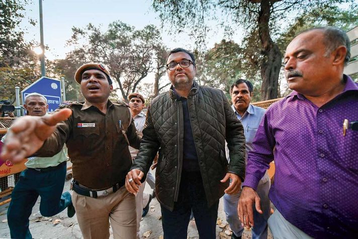 Karti Chidambaram (centre) after his arrest in Delhi