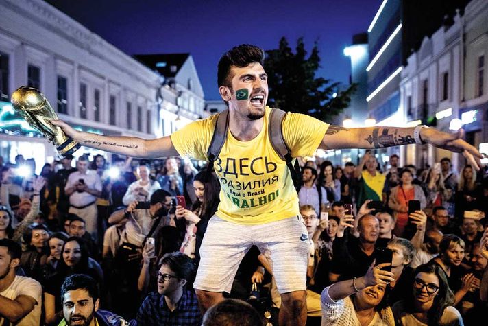 A Brazil football fan in a local market square