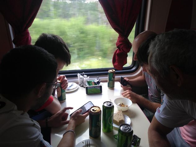 Fans watching football inside the train