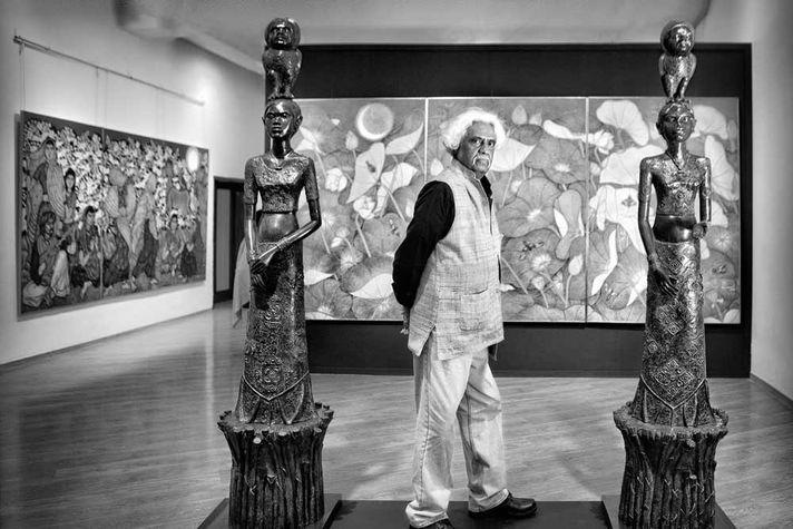 A Ramachandran with his paintings