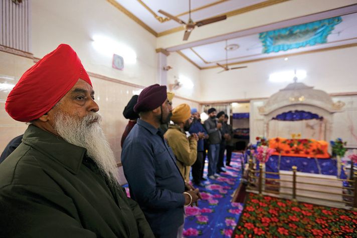 Sikhs assemble at the Gurudwara in Kanpur's Guru Nanak Market for evening prayers