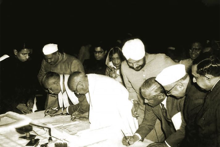 Members of the Constituent Assembly sign the first copies of the Constitution, January 25, 1950