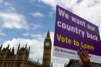 A demonstrator for the "Leave" campaign holds a placard outside Houses of Parliament in London on 15 June, 2016