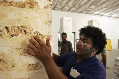 Chandraguptha Thenuwara adds final touches to his art at a gallery in Colombo