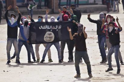 Protestors hold an Islamic State flag as they shout anti-India slogans in Srinagar