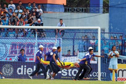 Choirul Huda is rushed off the field after a tackle. He died soon after