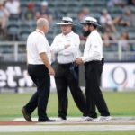 Umpires Ian Gould (C) Aleem Dar (R) and referee Andy Pycroft discuss ahead of suspending the match during the third day of the third test match