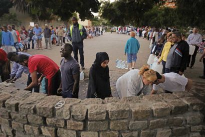 Capetonians queue up for water at a natural spring in Newlands