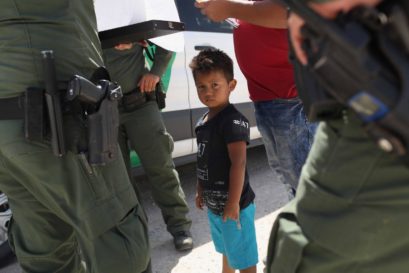 U.S. Border Patrol agents take into custody a father and son from Honduras near the U.S.-Mexico border on June 12, 2018 near Mission, Texas