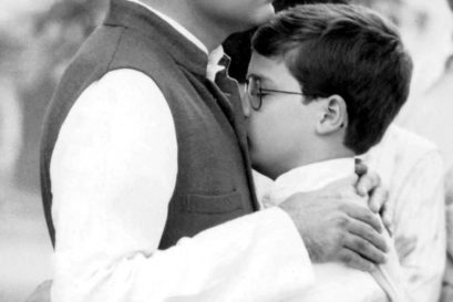 Rahul hugging his father at his grandmother's cremation