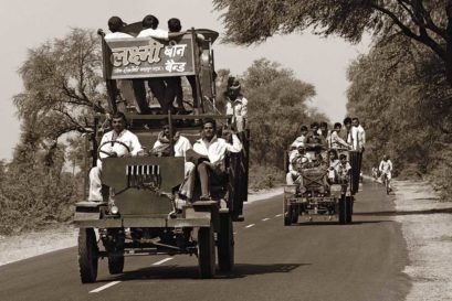 A makeshift band wagon trundles along a rural road