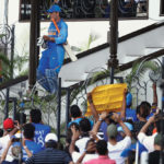 Fans greet Dhoni as he heads out to bat against Australia in India’s last ODI series before the World Cup