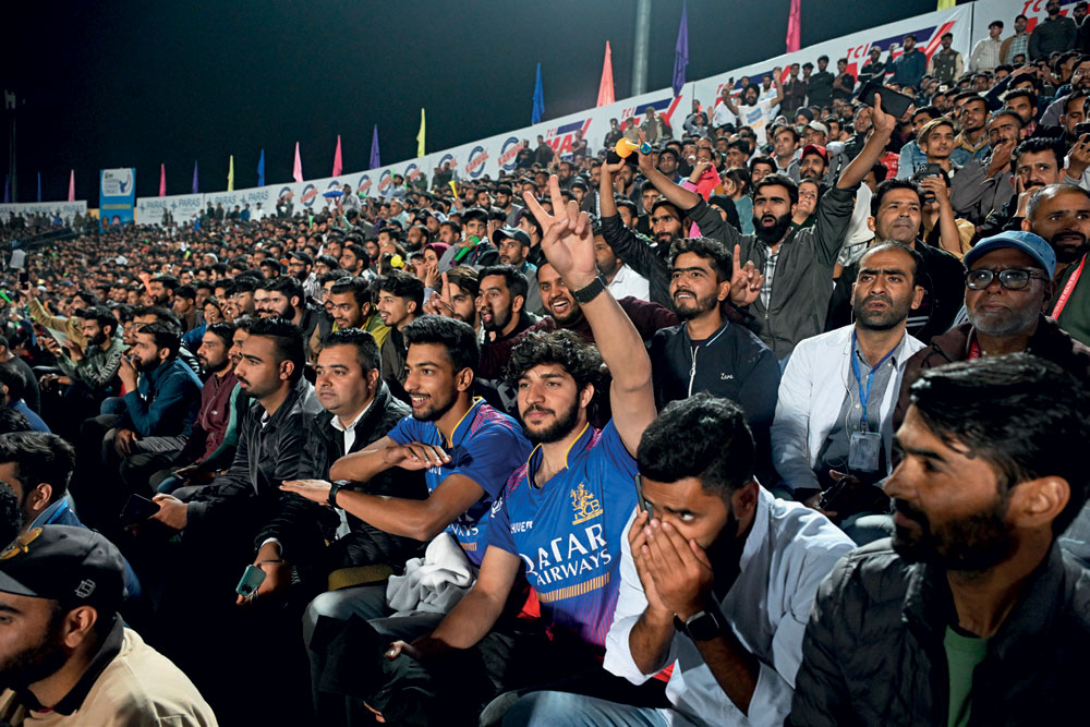 Cricket fans watch the Legends League T20 match at Bakshi Stadium, Srinagar