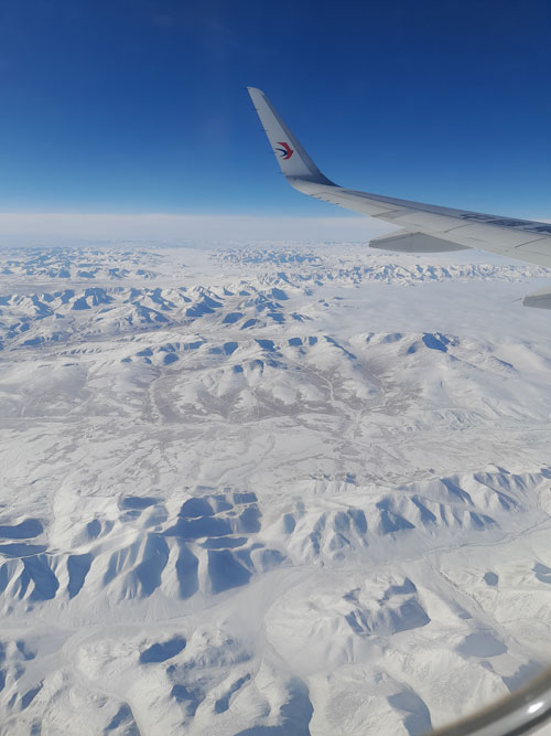 Flying over the snow-covered mountains of Gansu