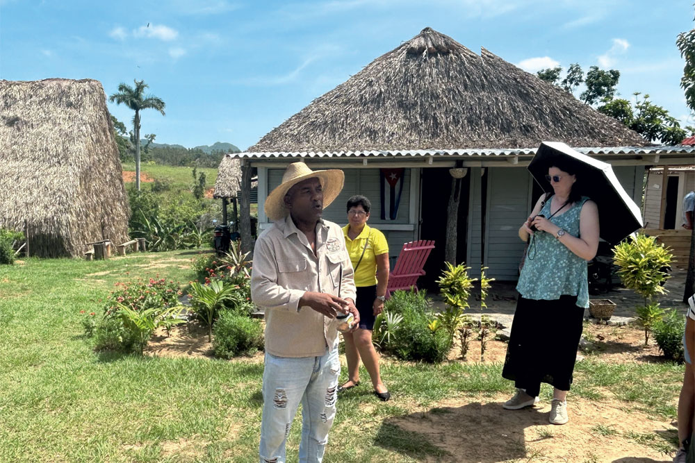 Nelson demonstrates the making of a cigar at his Pinar del Río tobacco farm