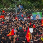 Fans of Royal Challengers Bengaluru (RCB) celebrate before the start of the trophy parade after they win the 2025 IPL, on June 04, 2025 in Bengaluru