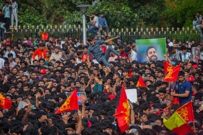 Fans of Royal Challengers Bengaluru (RCB) celebrate before the start of the trophy parade after they win the 2025 IPL, on June 04, 2025 in Bengaluru