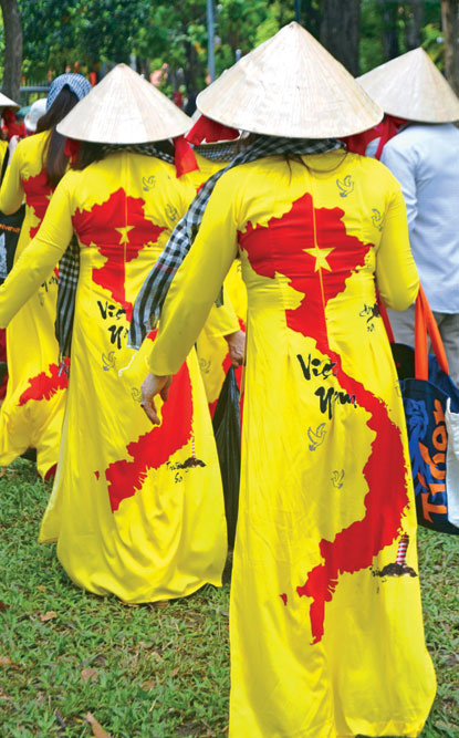 Women in the traditional ao dai printed with the map of Vietnam